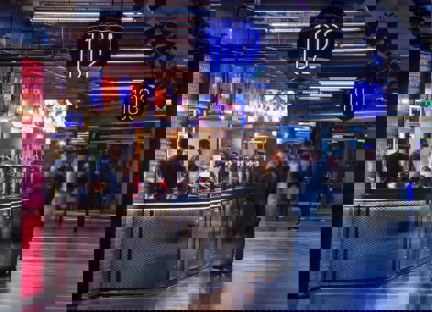 A bar area at the O2 Arena in London with Constellation staff standing behind the bar.